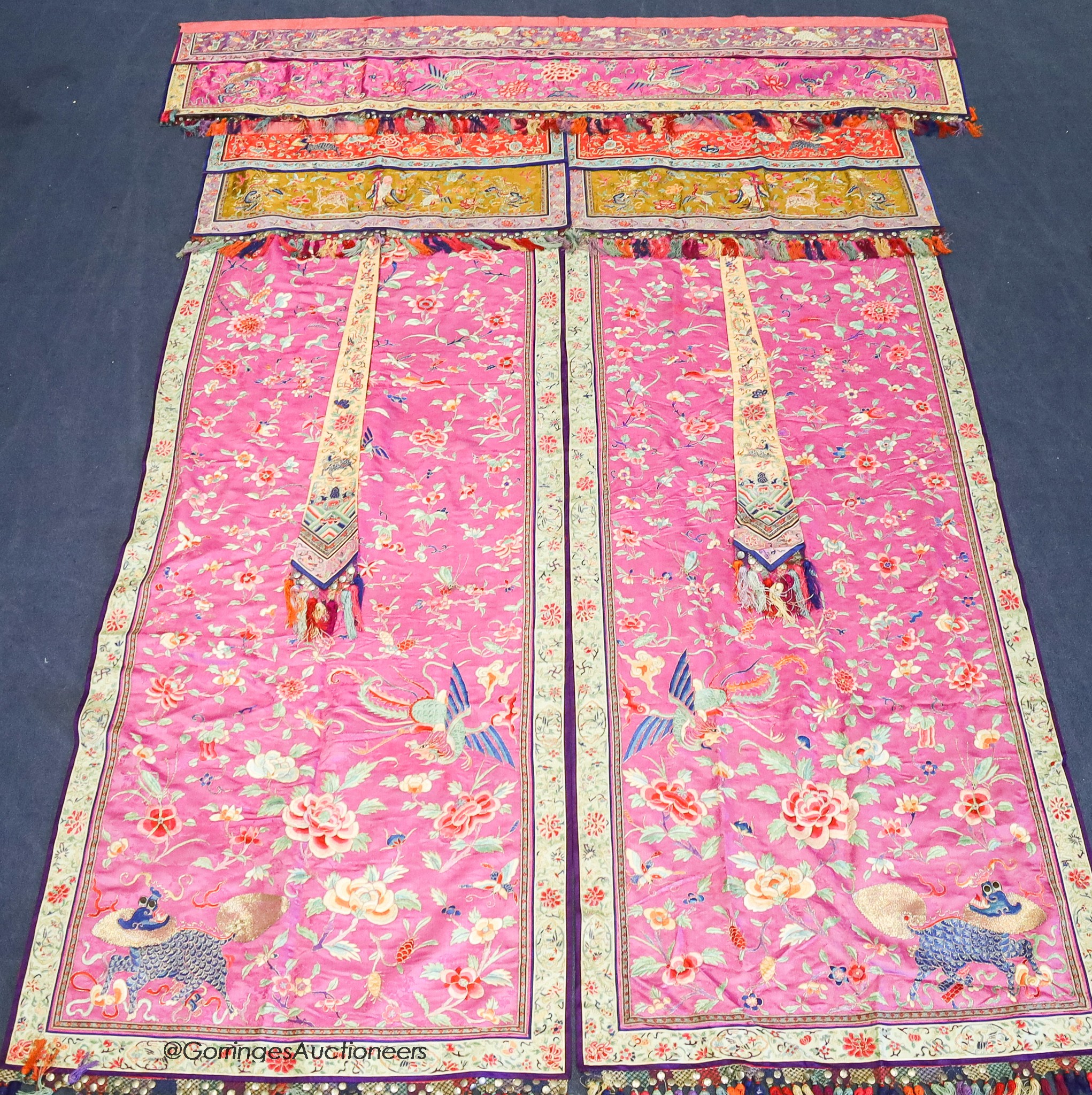 A pair of 20th century Chinese silk embroidered ceremonial panels, possibly for a wedding, 228cm not including fringing, each panel width 80cm, with a matching pelmet, width 198cm